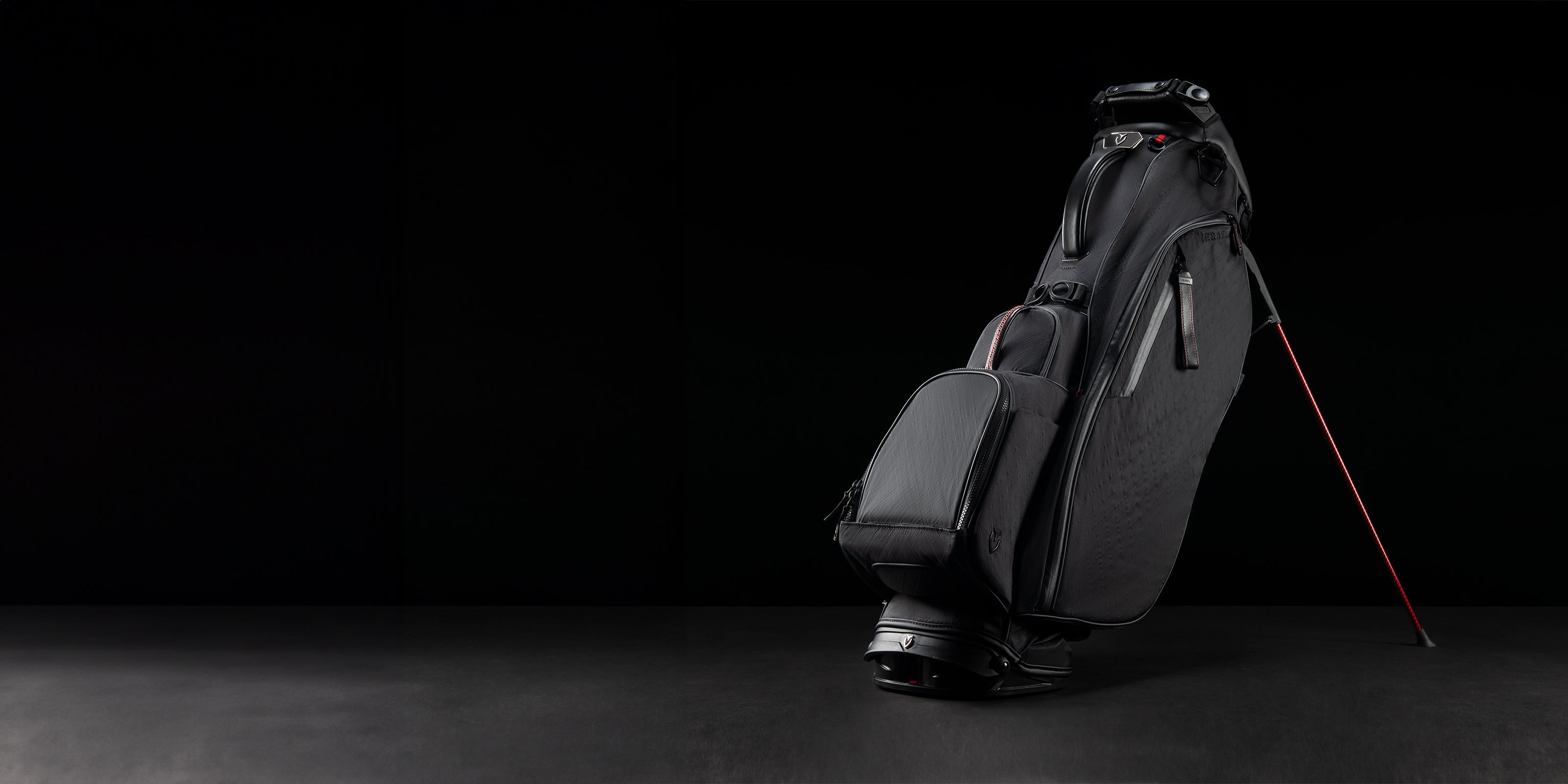 Black DXR Player V Stand Bag, with red accents on a black background.