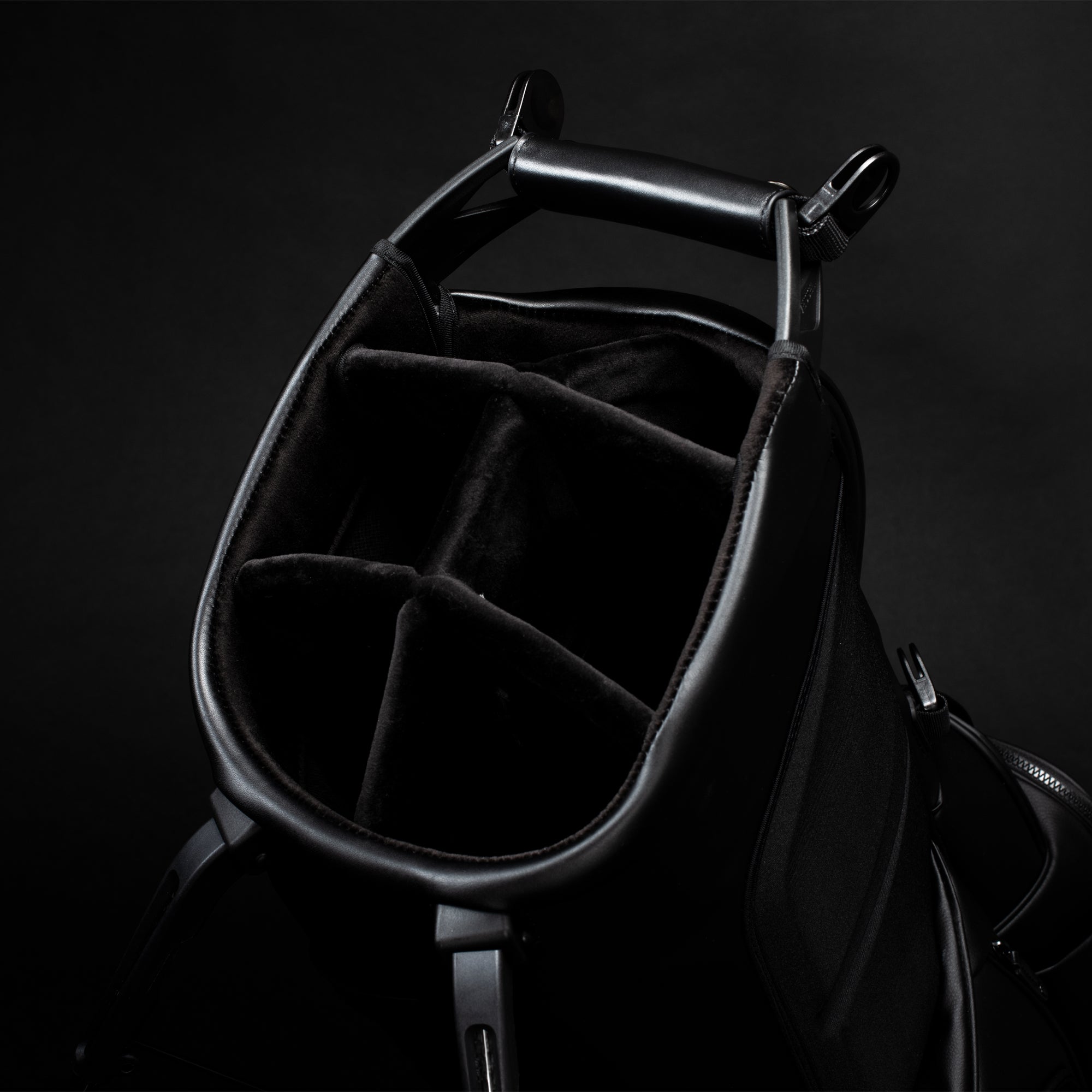 Close up photo of the 6-way divider in a black Player IV Pro stand bag in a black studio