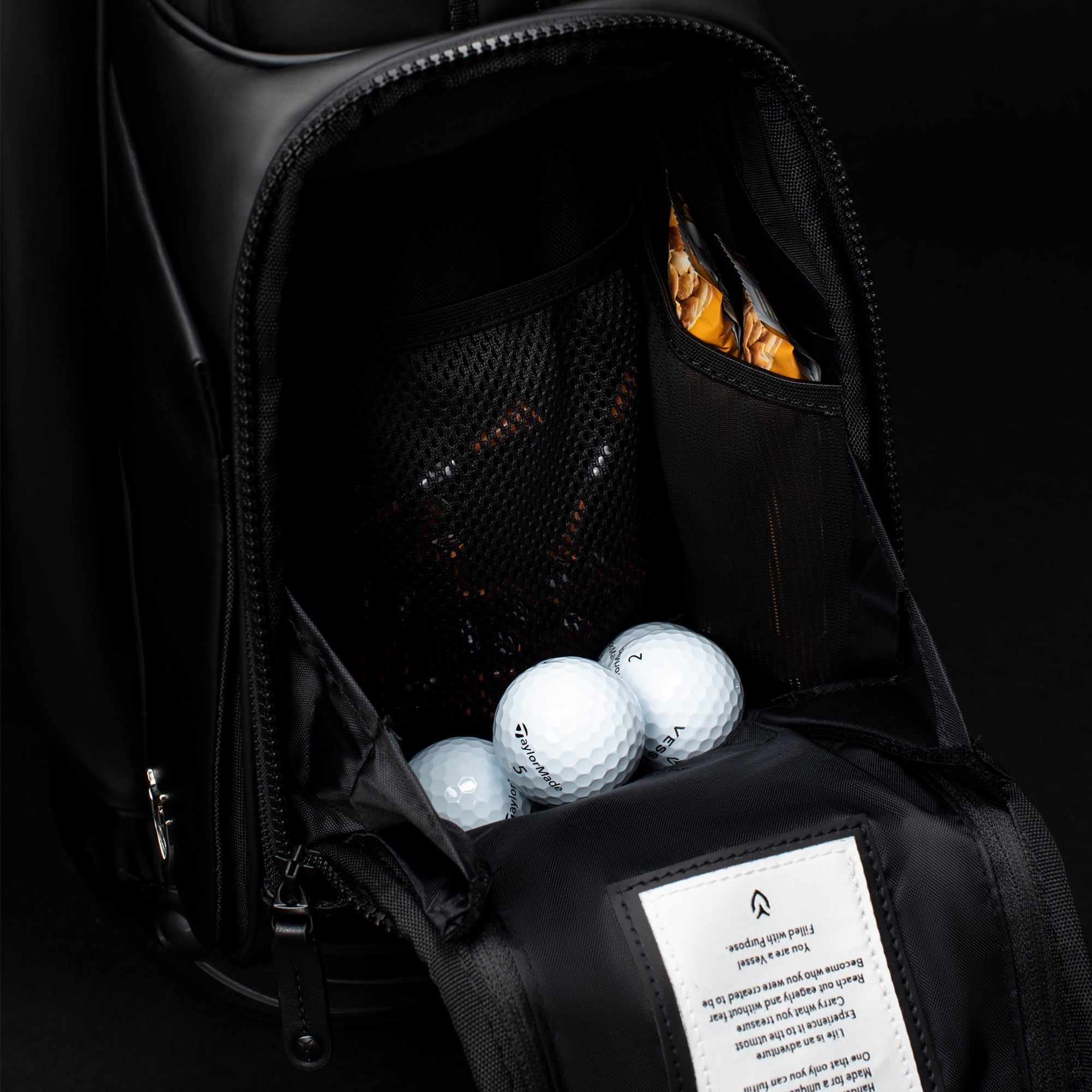 Close up of golf bag ball pocket with snacks and golf balls