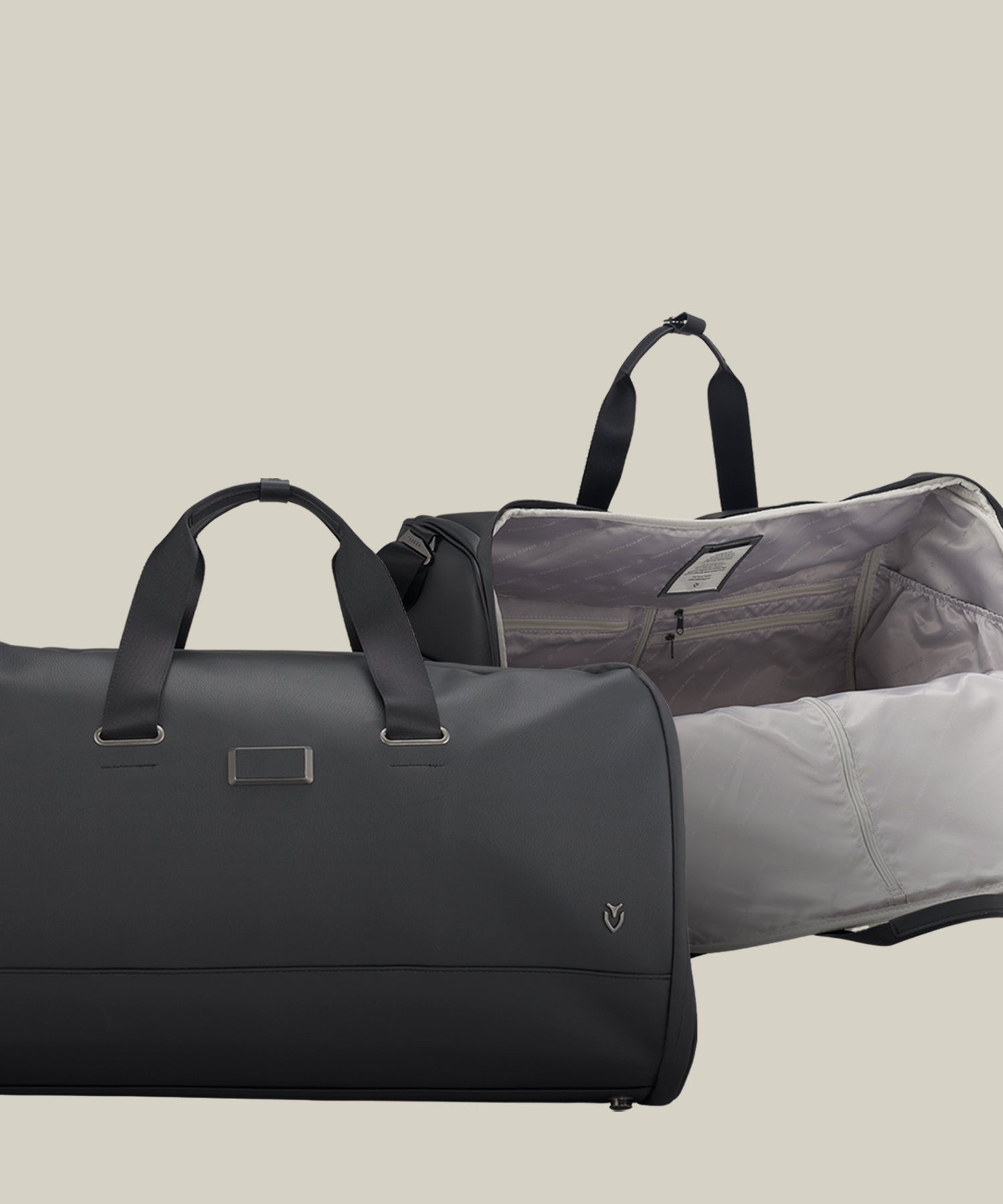 Two black Garment Duffel bags against a taupe background. One bag is open