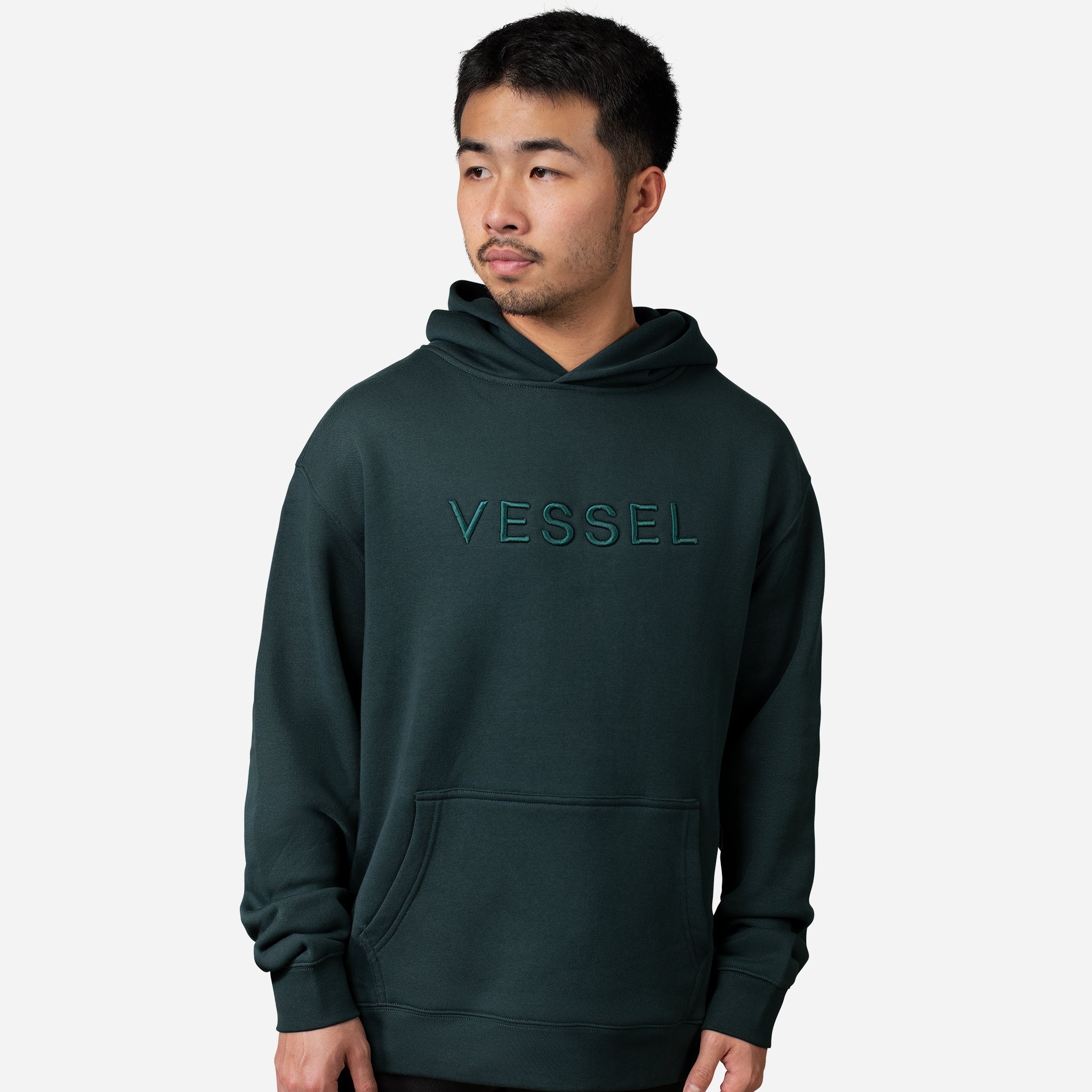 Man wearing green VESSEL Hoodie #color_green