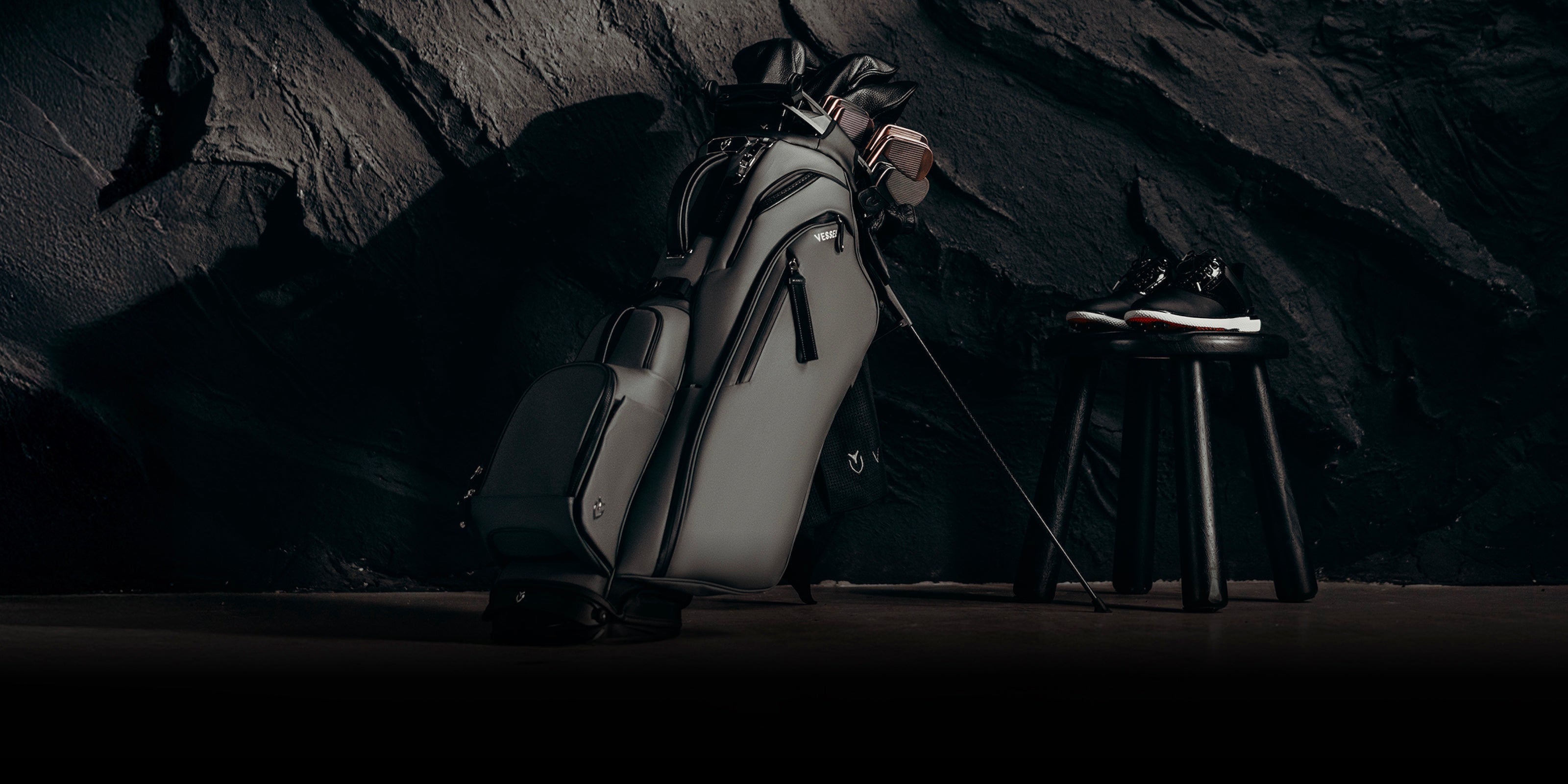 Grey player V Pro golf bag next to a pair of golf shoes