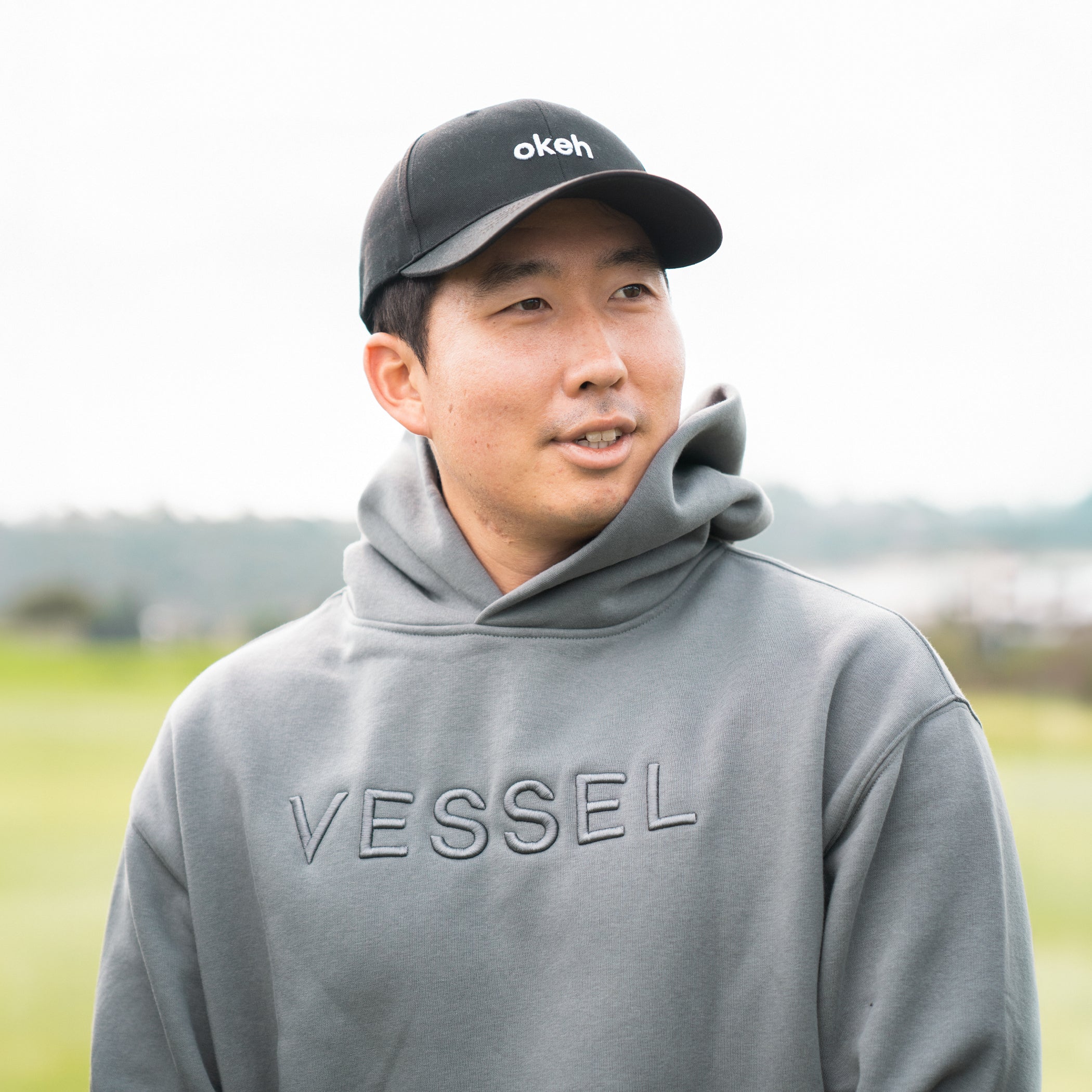 Man outside wearing grey VESSEL Hoodie #color_grey