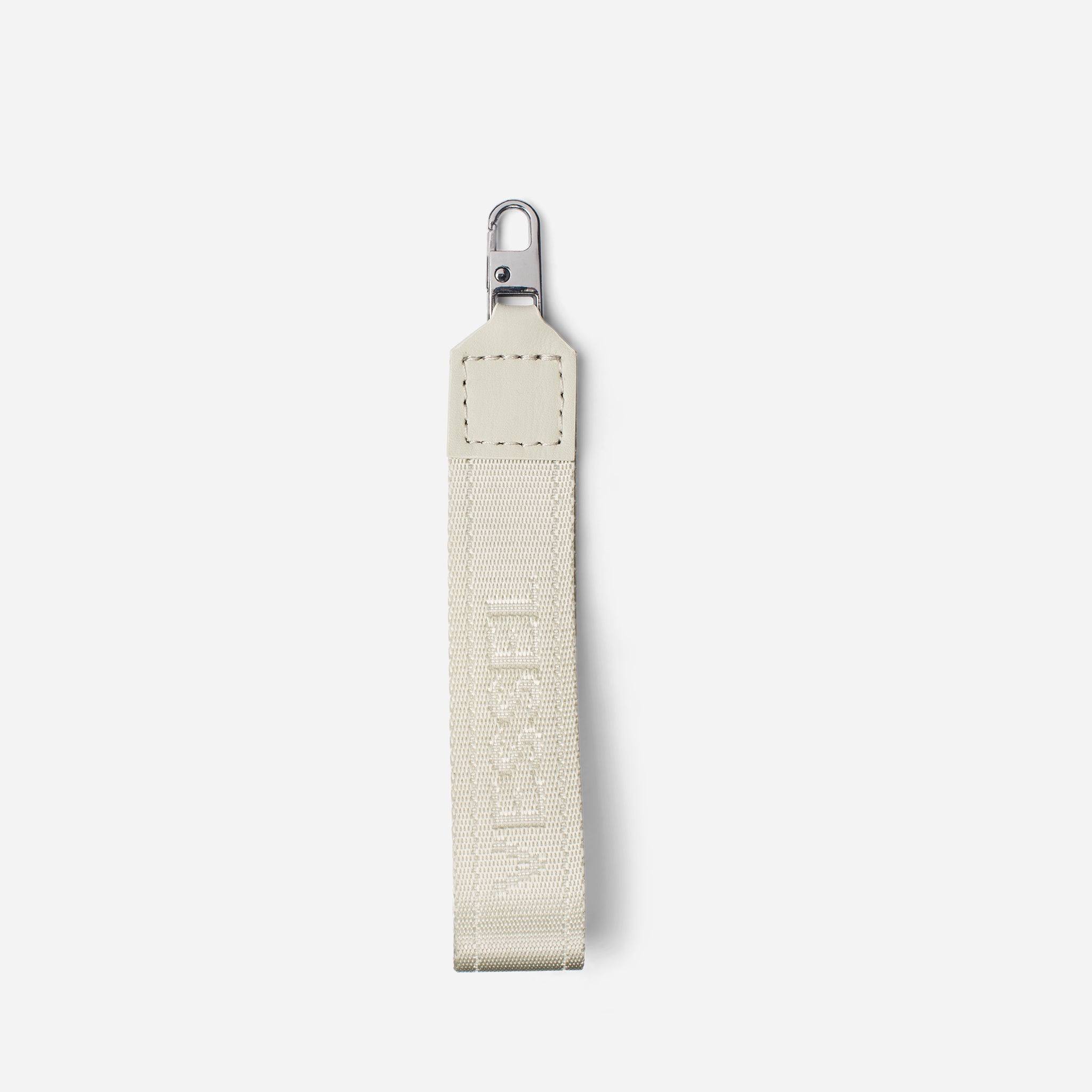 White jacquard fabric loop zipper pull against a white background