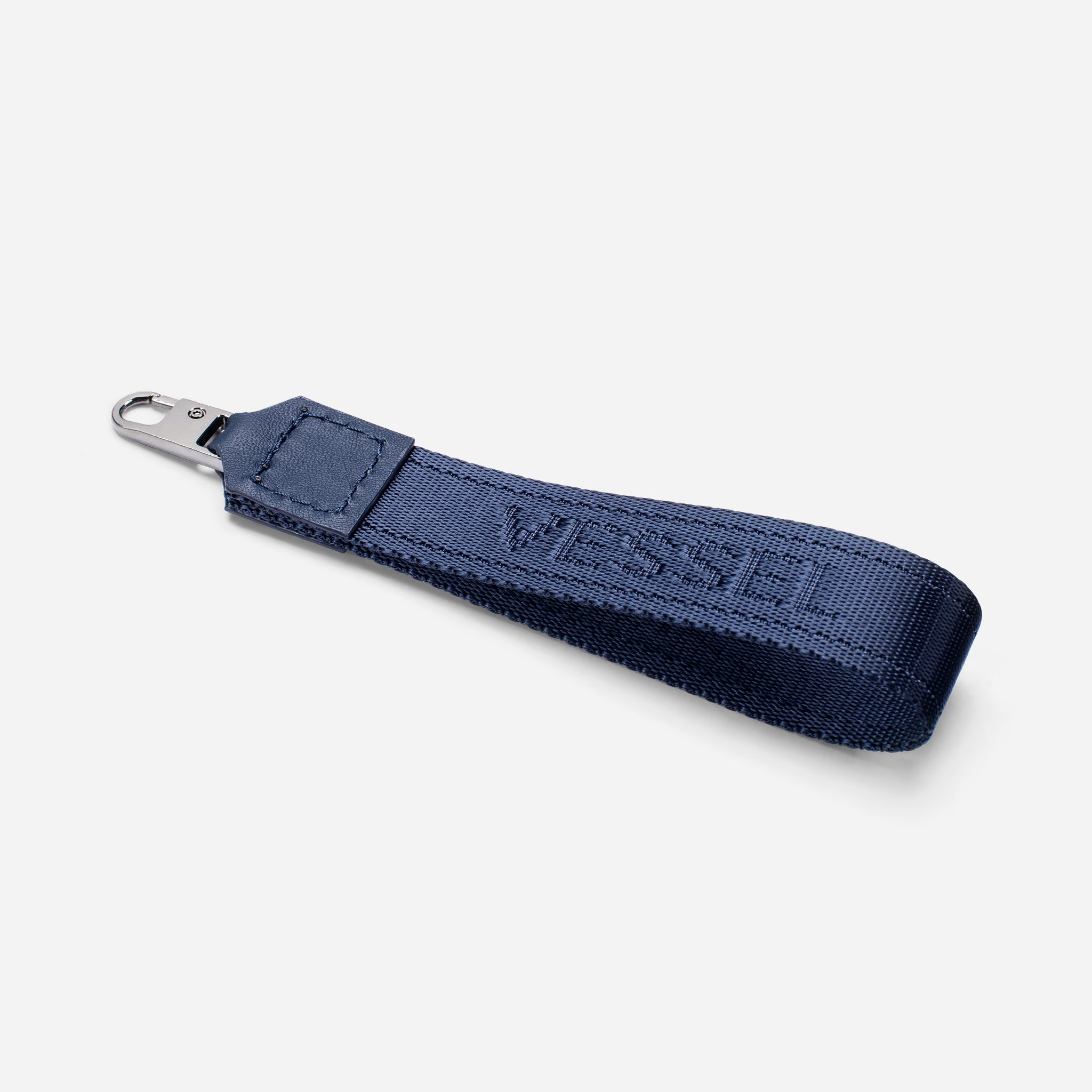 Navy jacquard fabric loop zipper pull against a white background at an angle