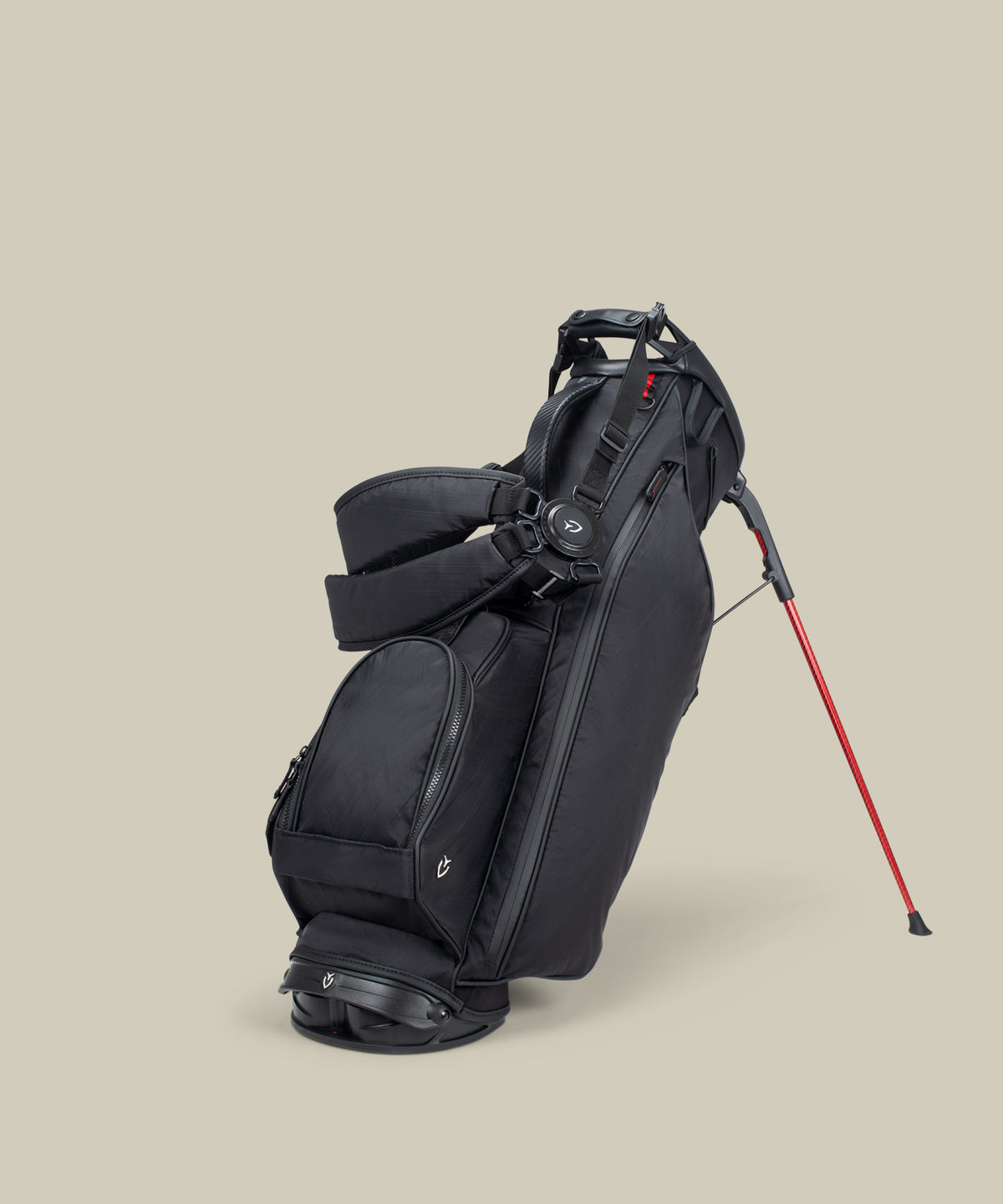 A Black, with red accent Junior Stand bag on a taupe background
