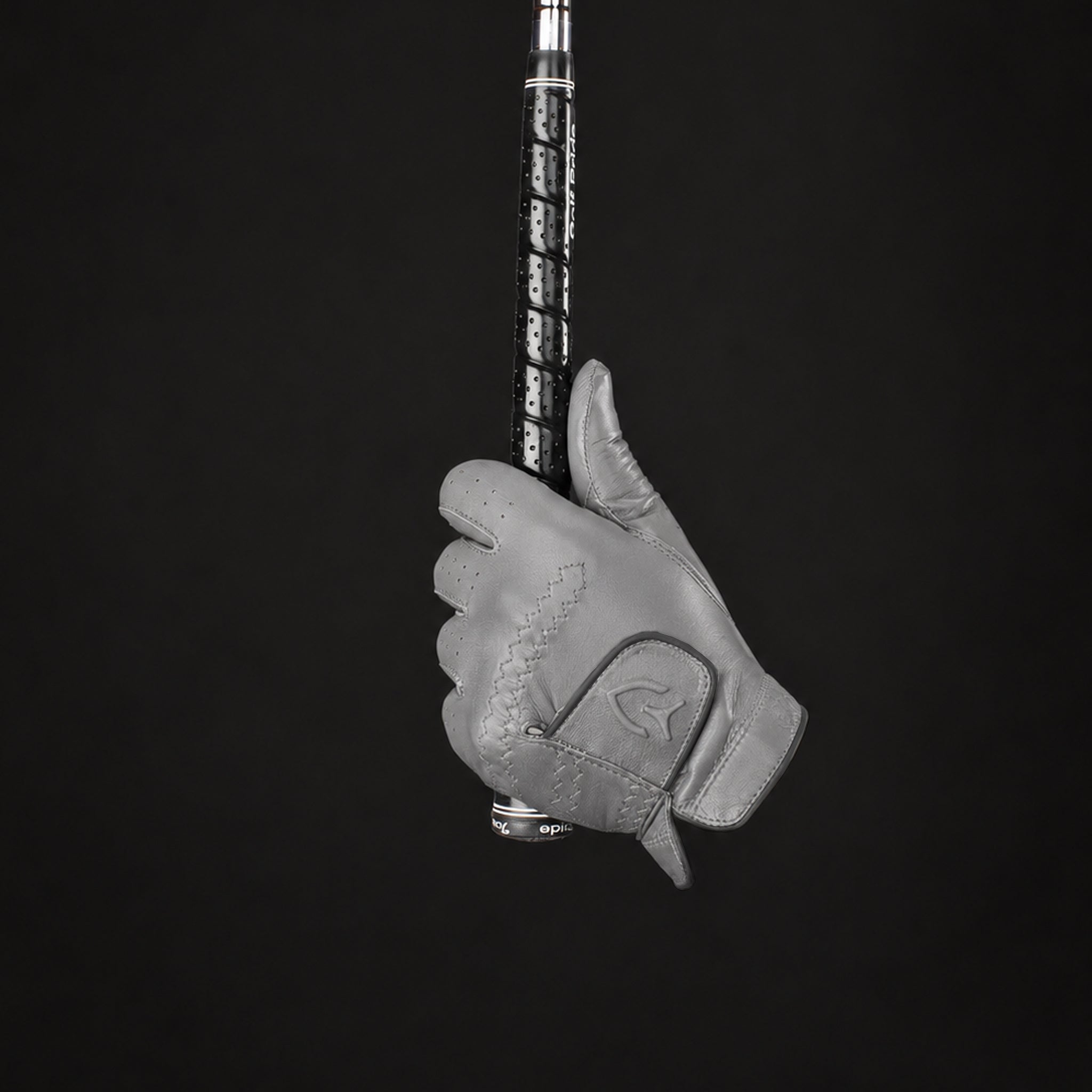 grey golf glove holding a golf club