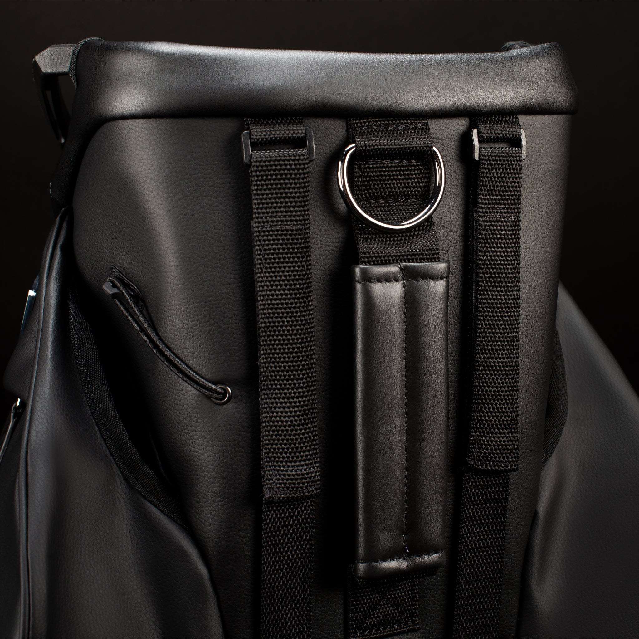 Backside of black leather golf cart bag with bracket cart straps 