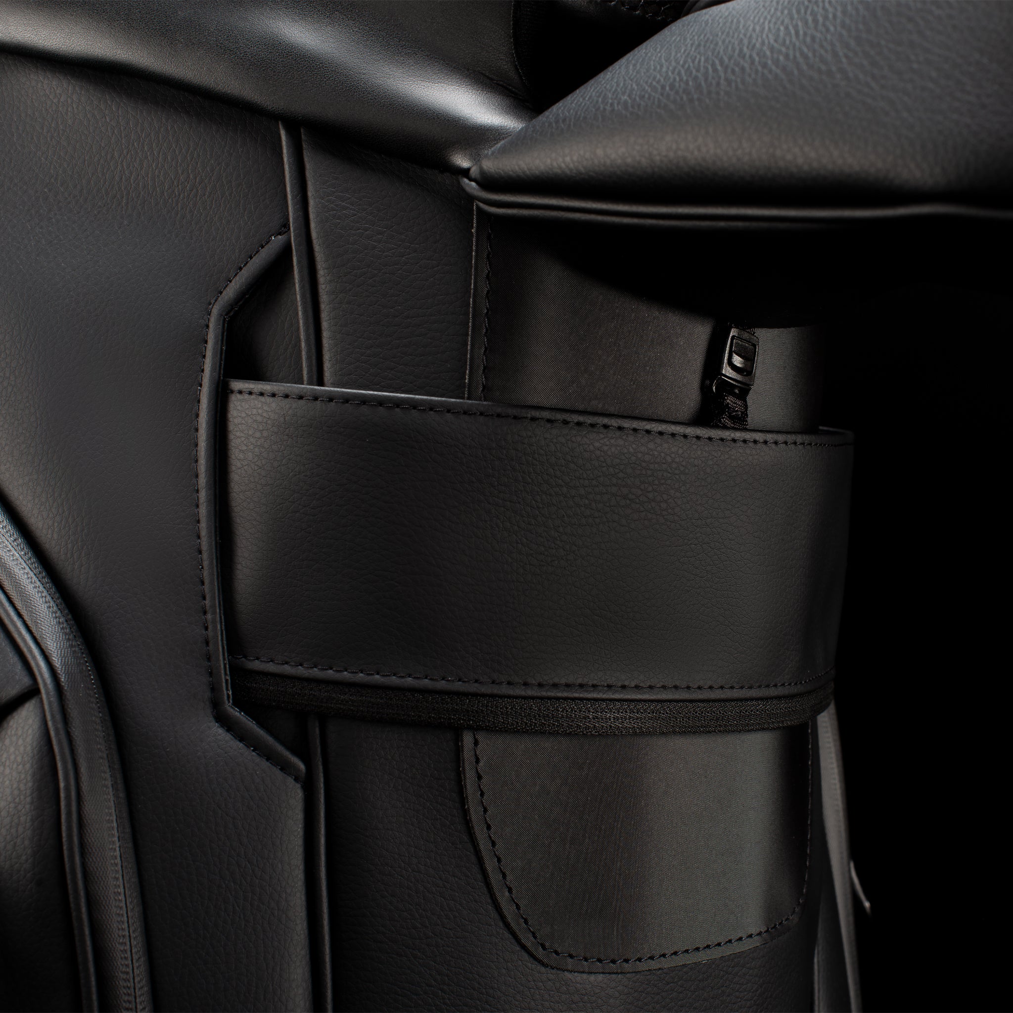 Close up of cart strap click under pocket on black leather cart bag
