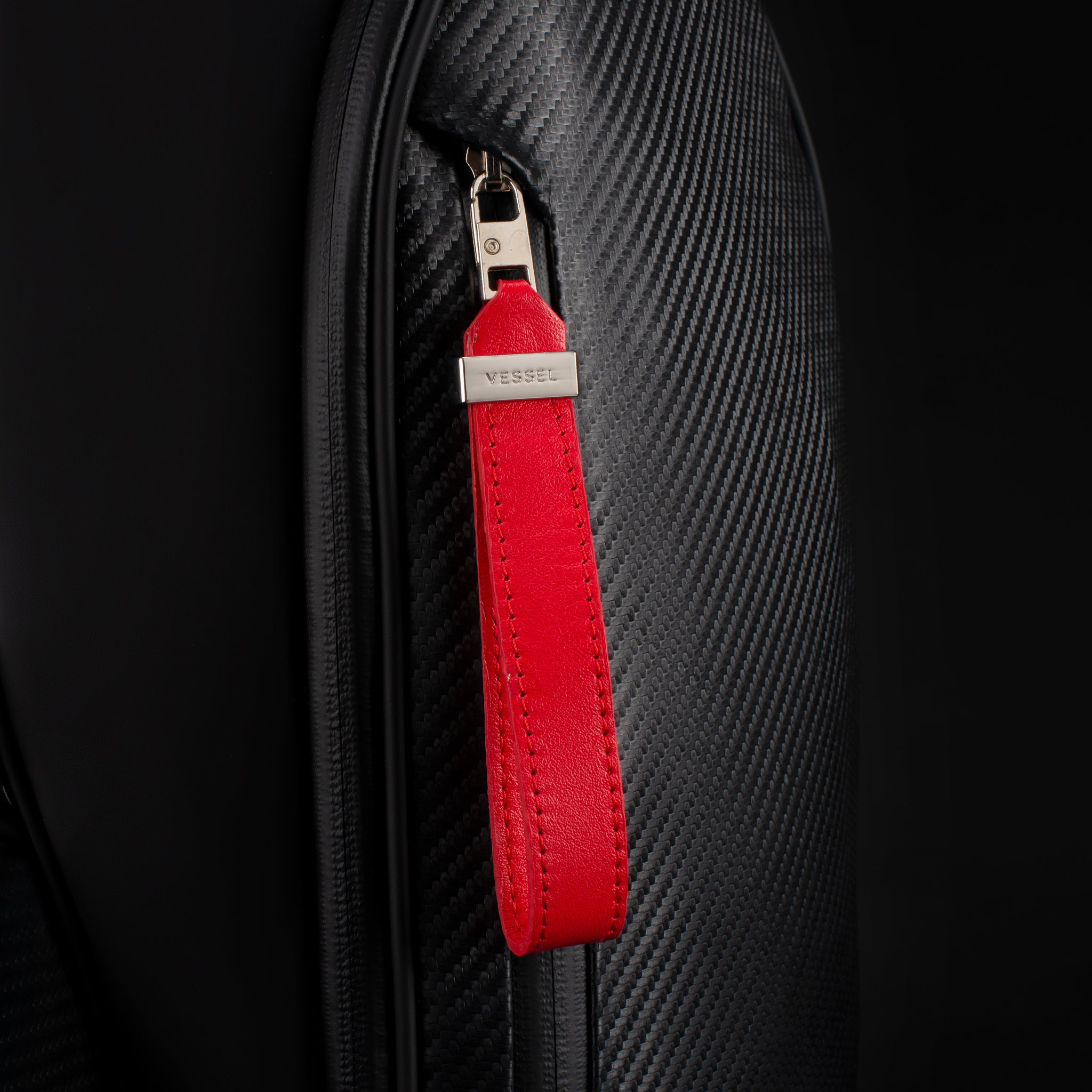 Close up of red leather zipper pull on nightfire lux cart ii golf bag