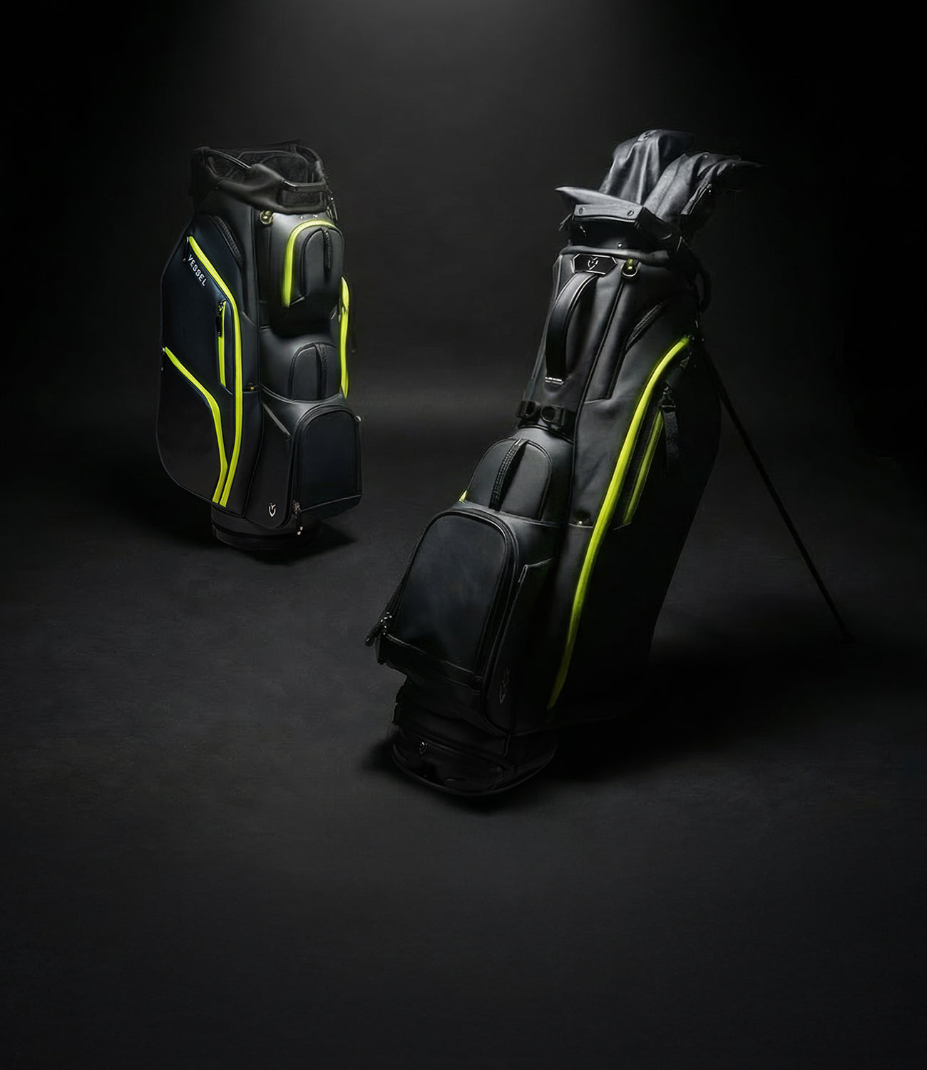 Two black and neon yellow golf bags against a black background
