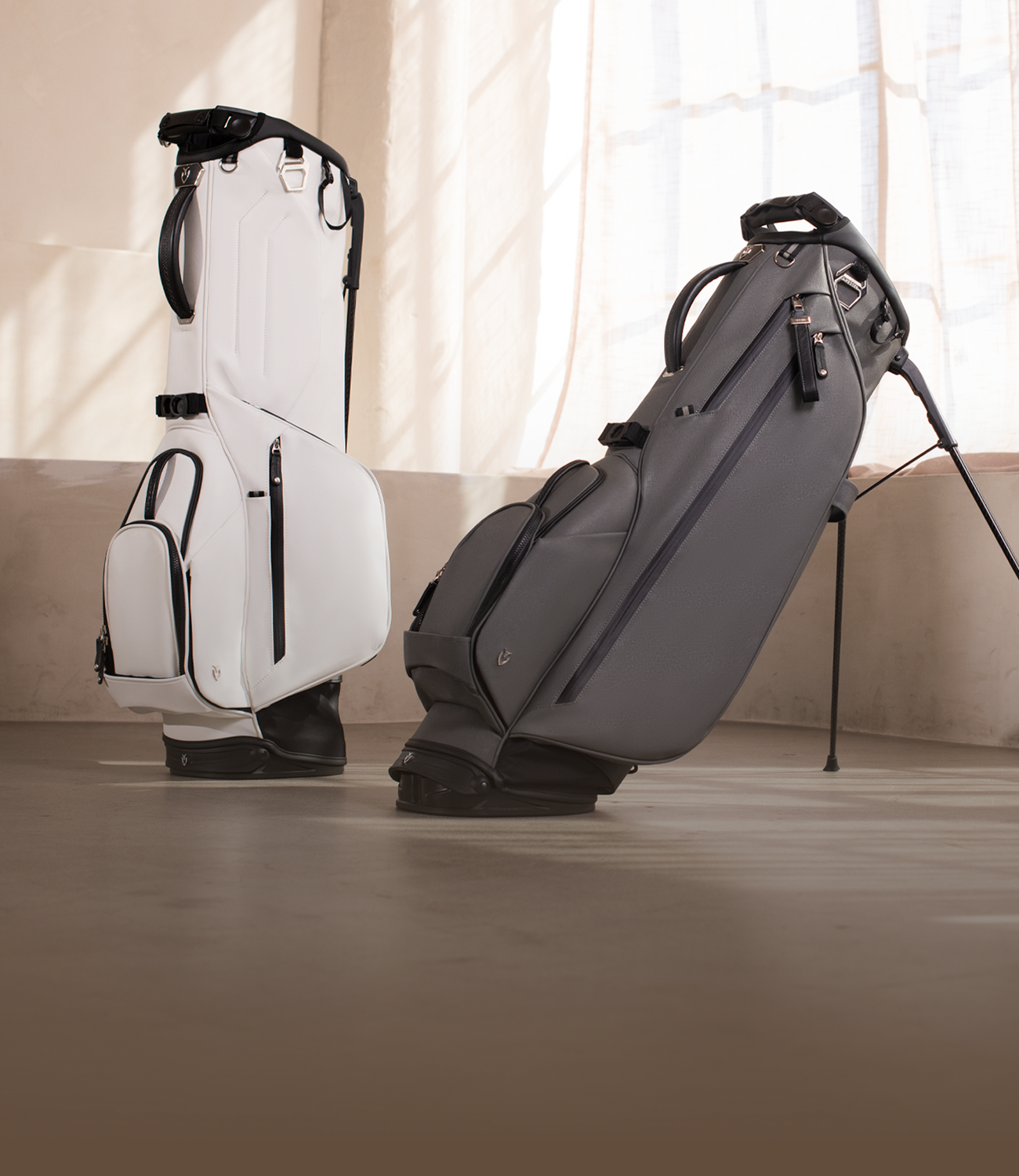 Two golf bags standing in a concrete room