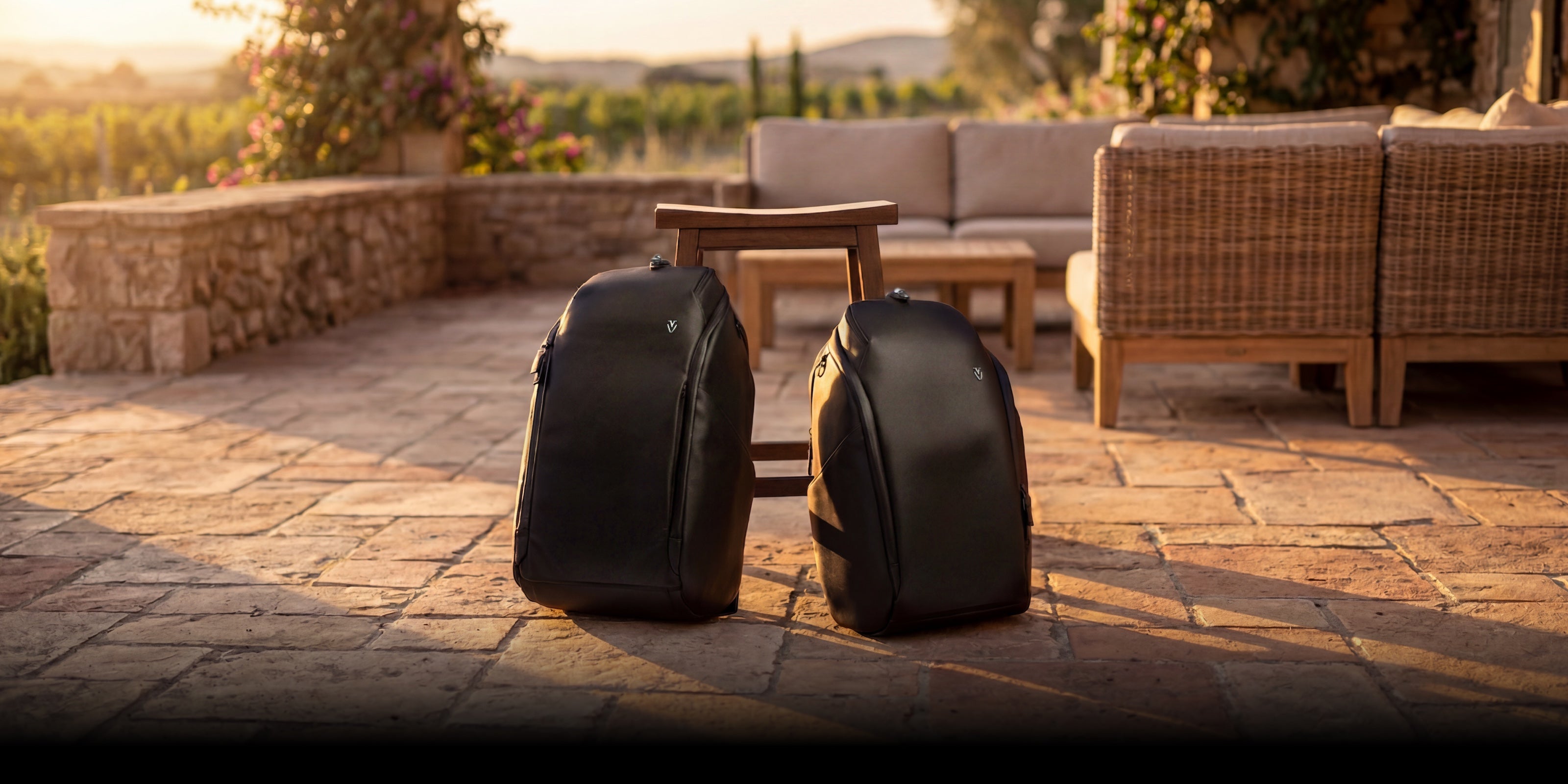 Two black leather backpacks in golden hour lighting