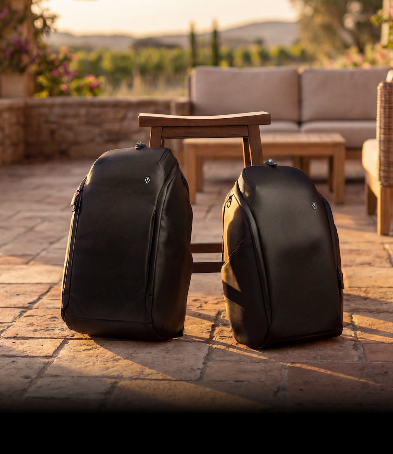 Two black leather backpacks in golden hour lighting