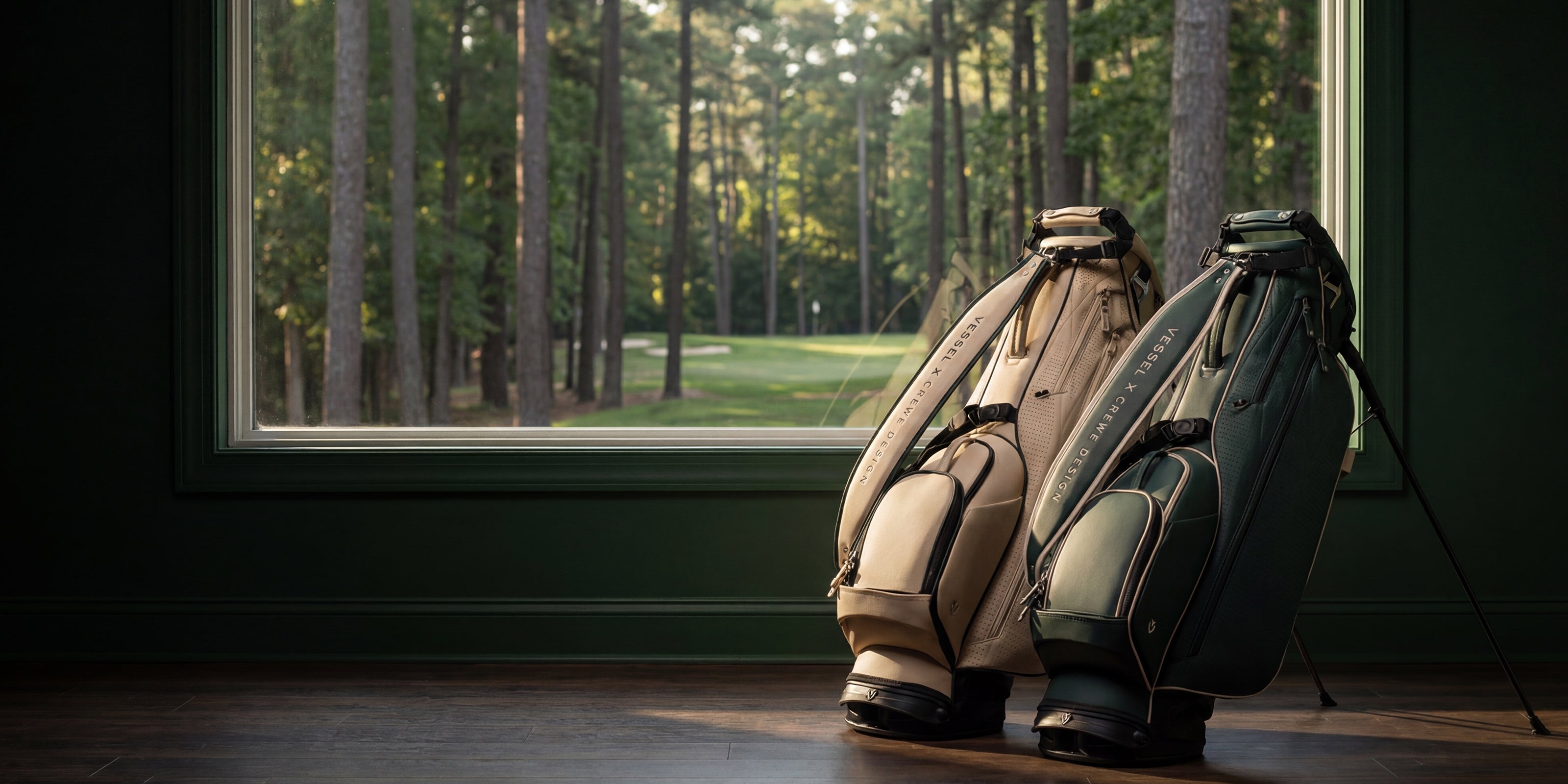 Two leather golf stand bags in a green bedroom next to a window