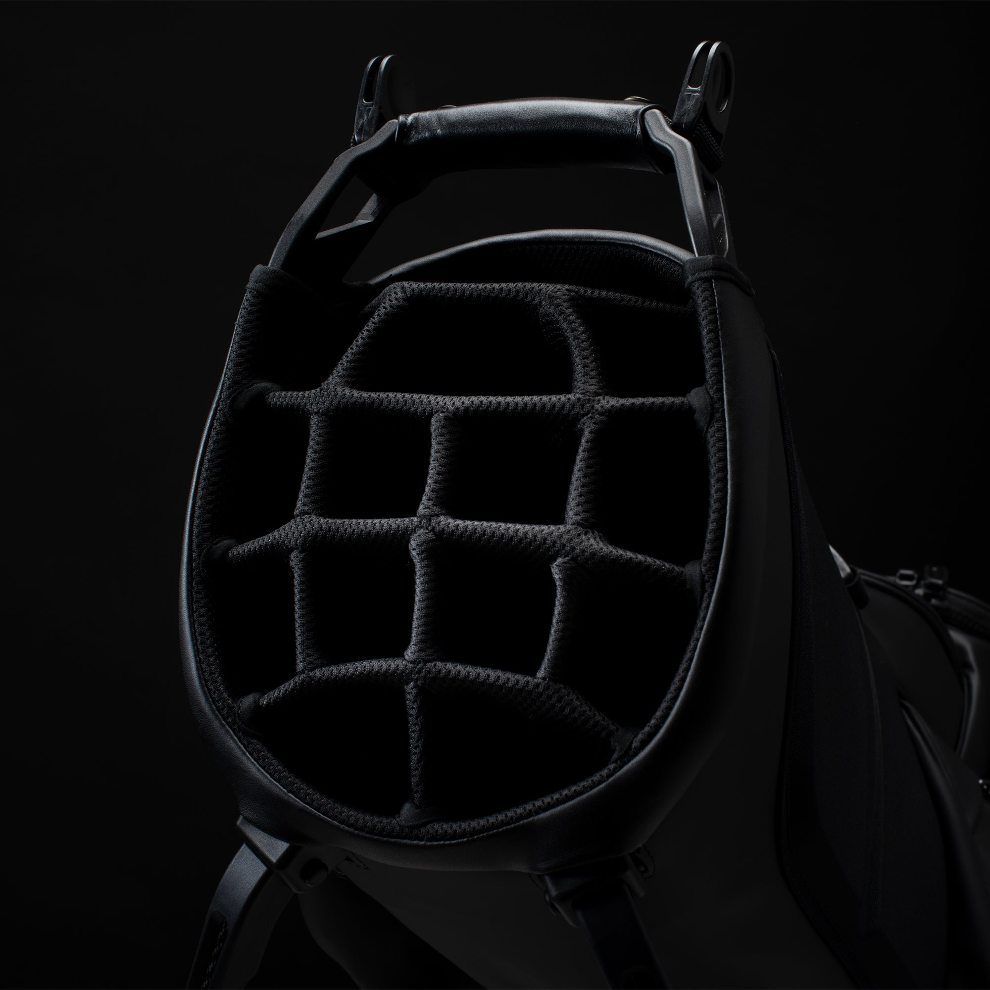 Close up image of the 14-way divider layout in a black golf bag in a black studio