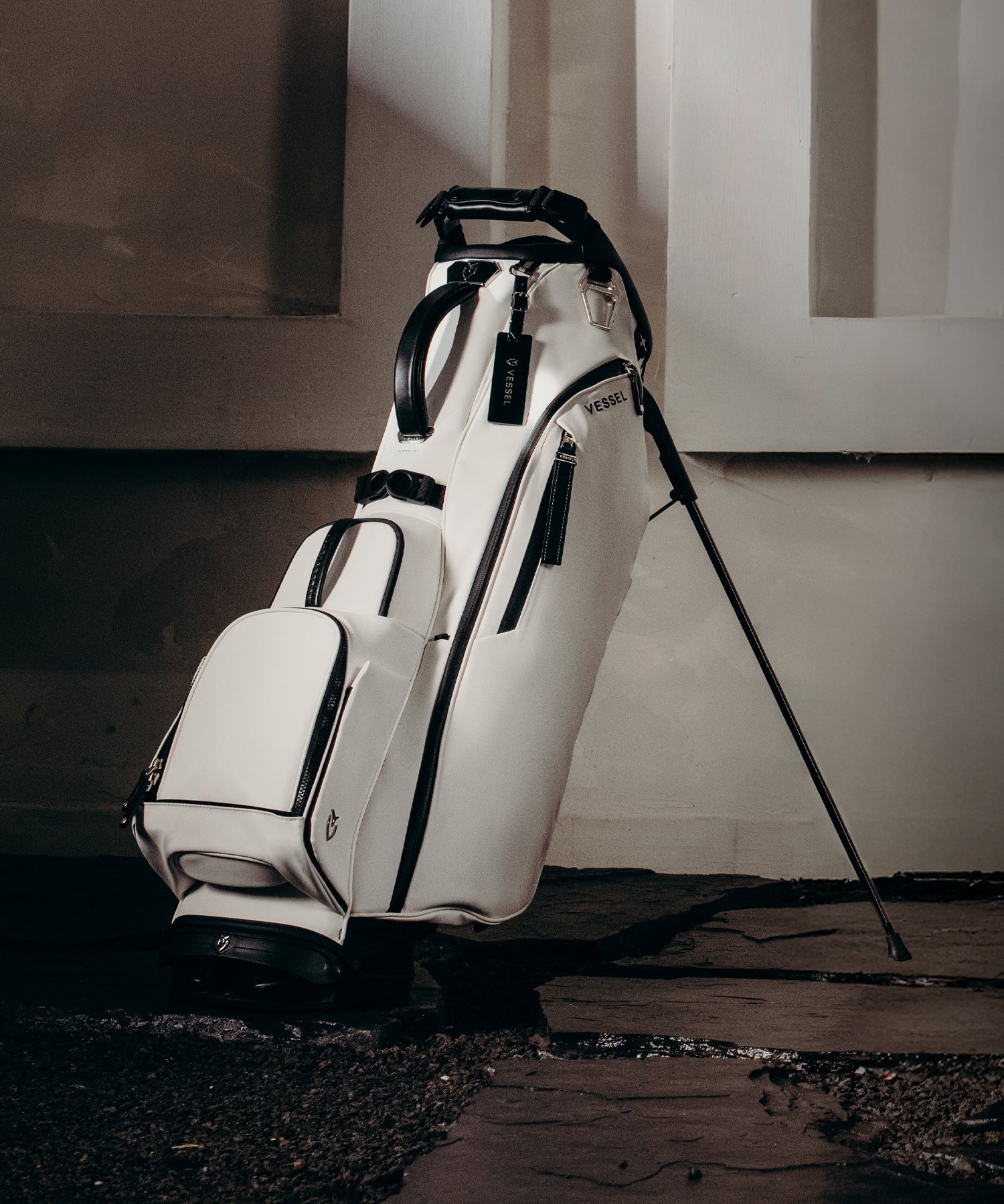White leather golf bag on a flagstone path