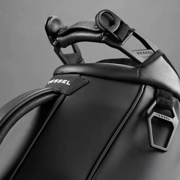 Strap connecters on top of black golf stand bag