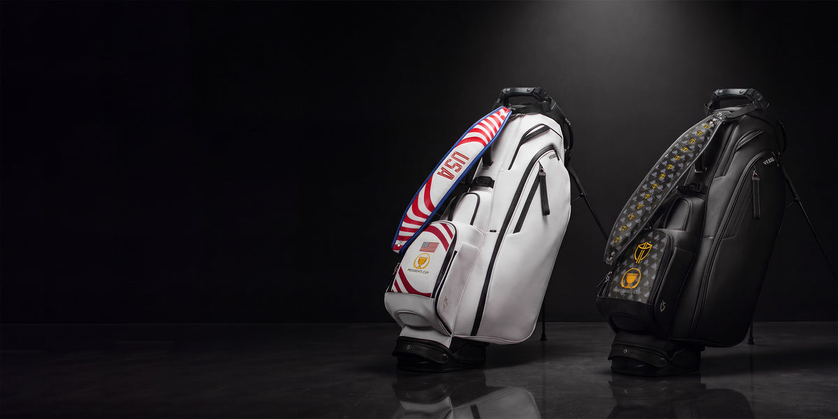 A black and a white presidents cup golf bag against a black background