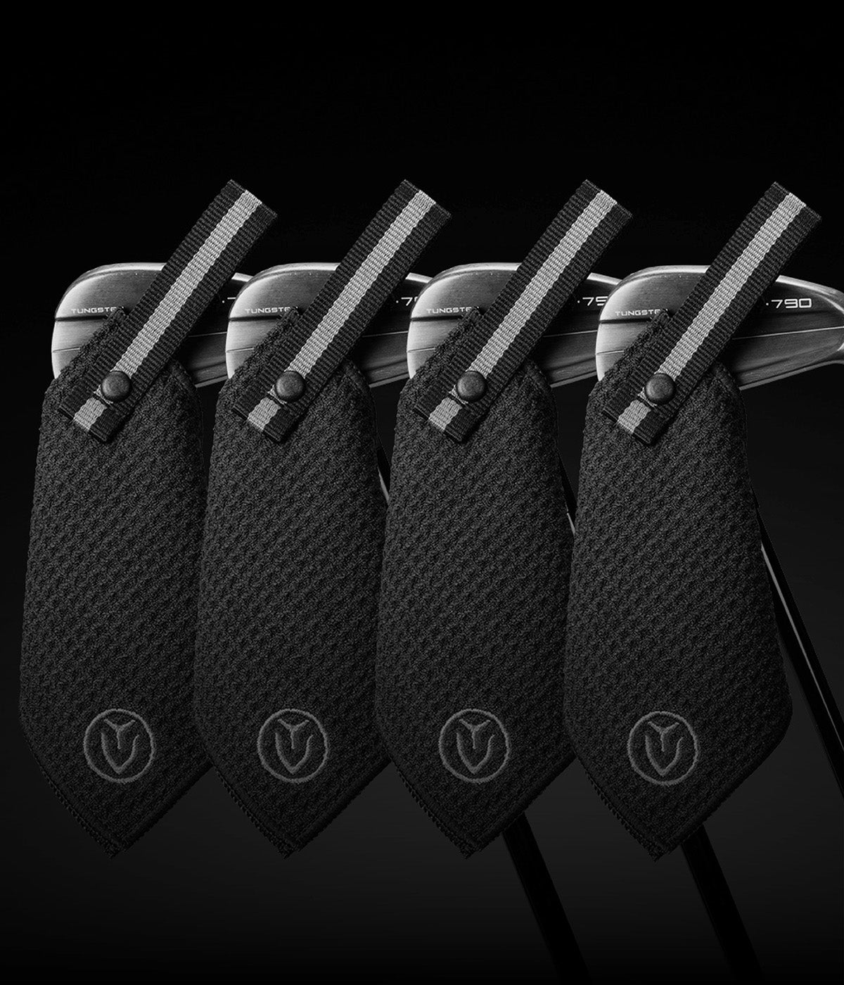 Four small magnetic golf towels stuck to four golf irons