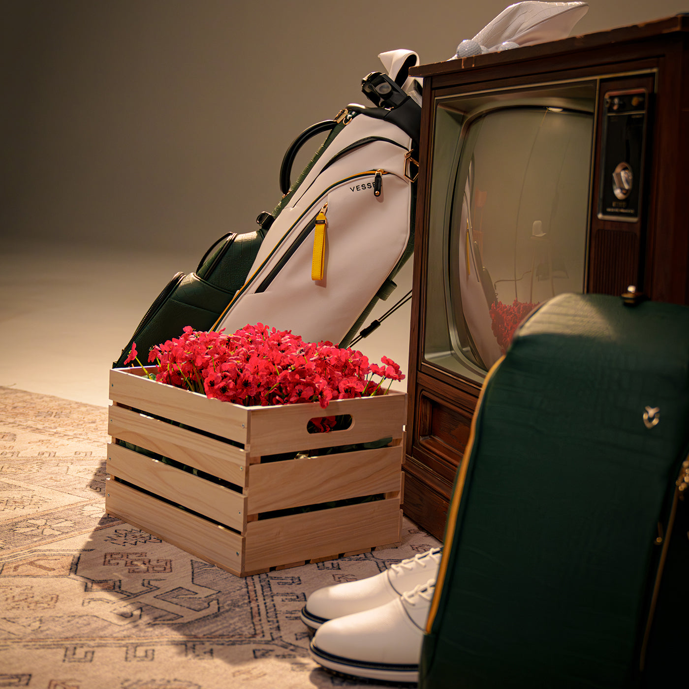 leather golf bags next to old tv