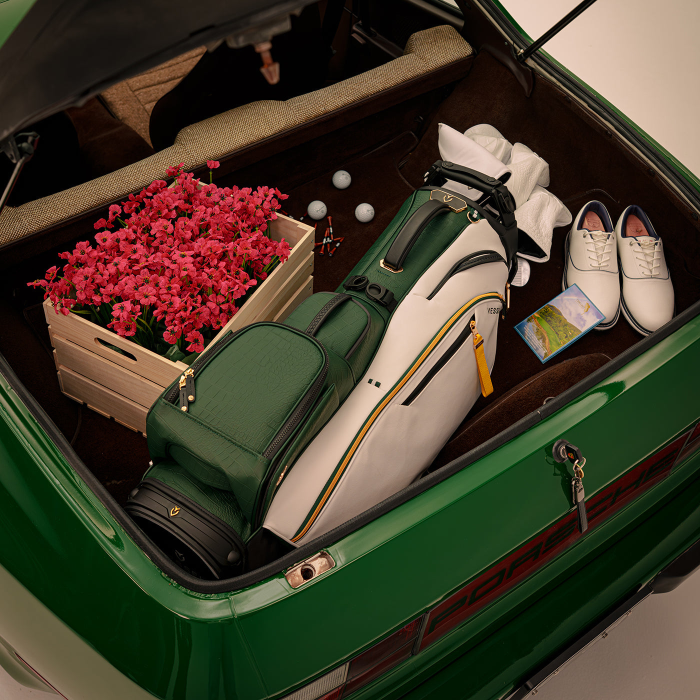 Season opener leather golf bag inside of green porsche trunk