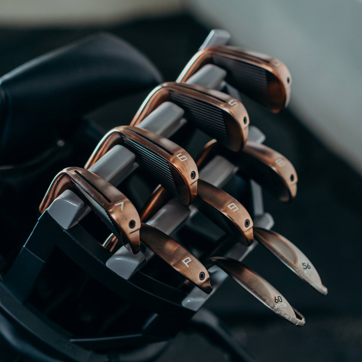 Bronze golf irons in a golf club organizer