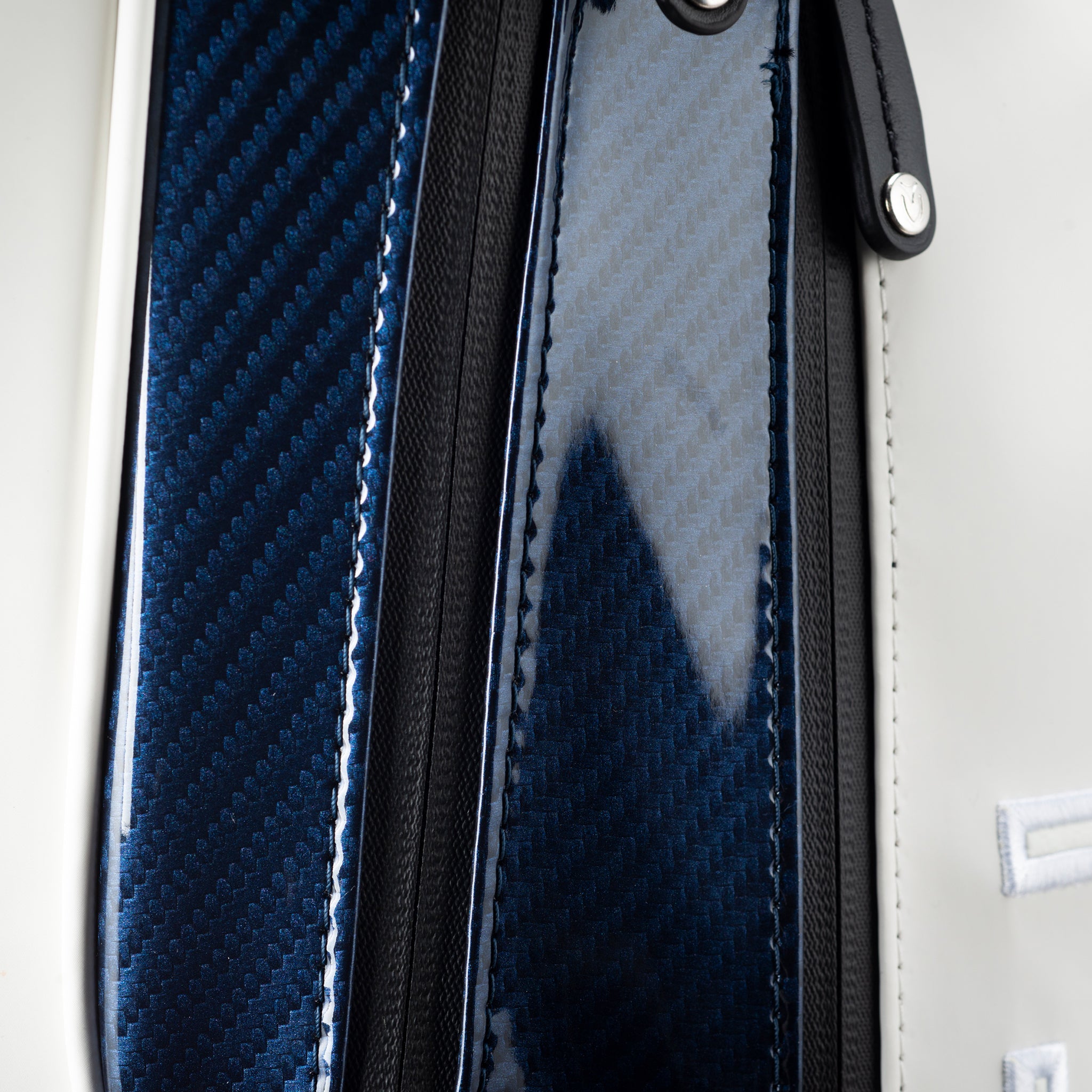 Close up image of carbon navy material on golf bag
