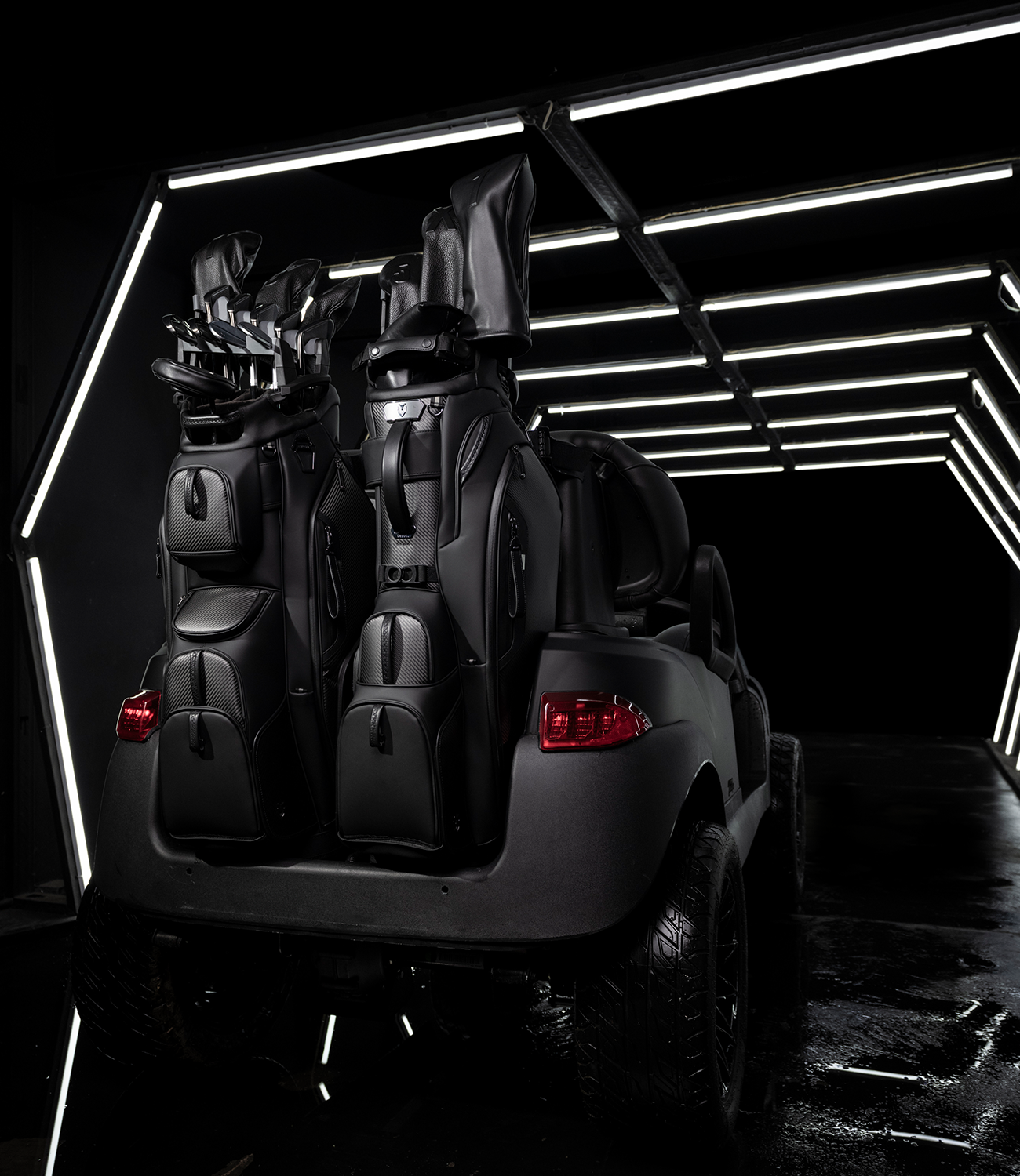 The Lux Pro Carbon Cart and Player V Pro Carbon Stand Bag on a Golf Cart surrounded by led lights.