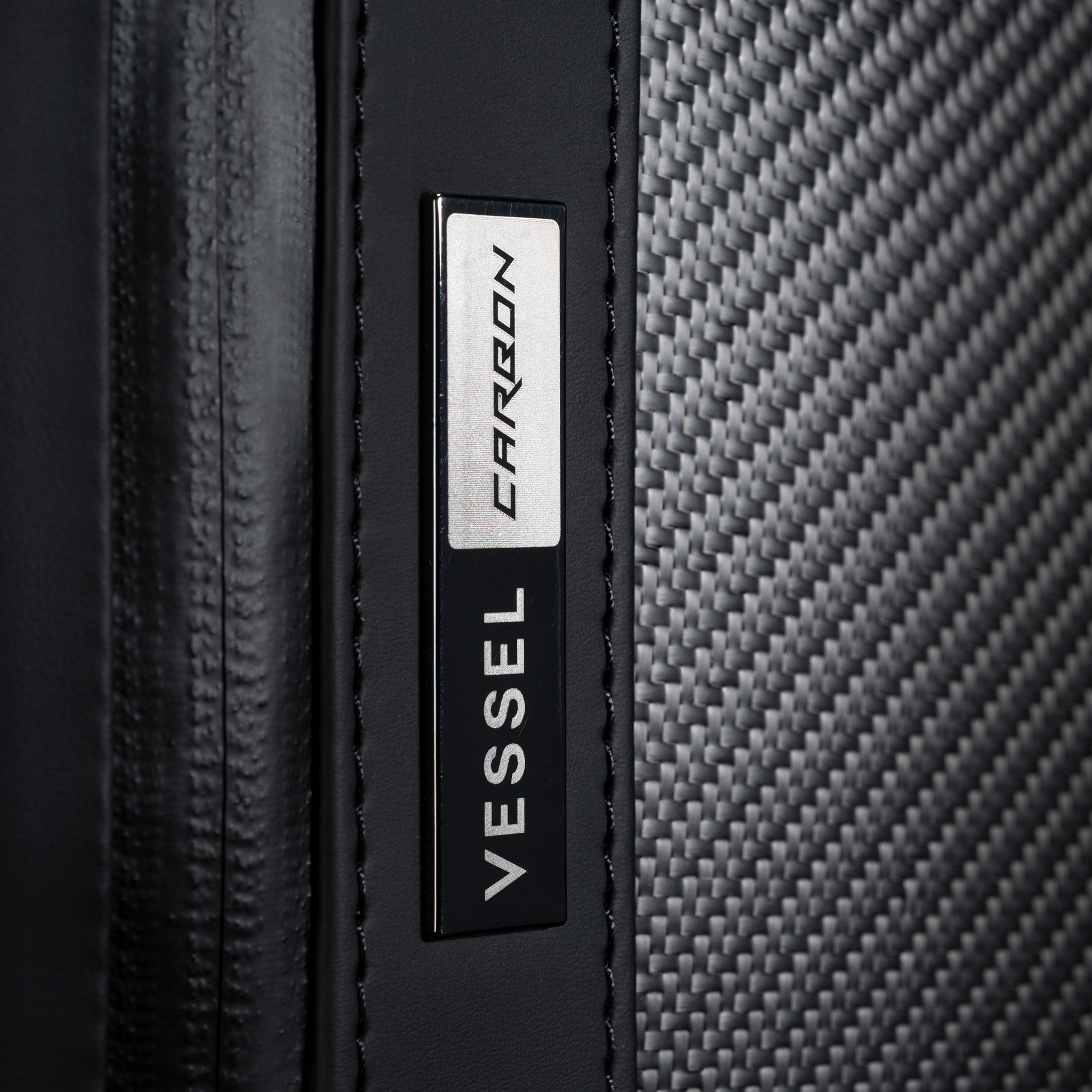 Close up of the metal chrome badge on each Carbon Collection bag.