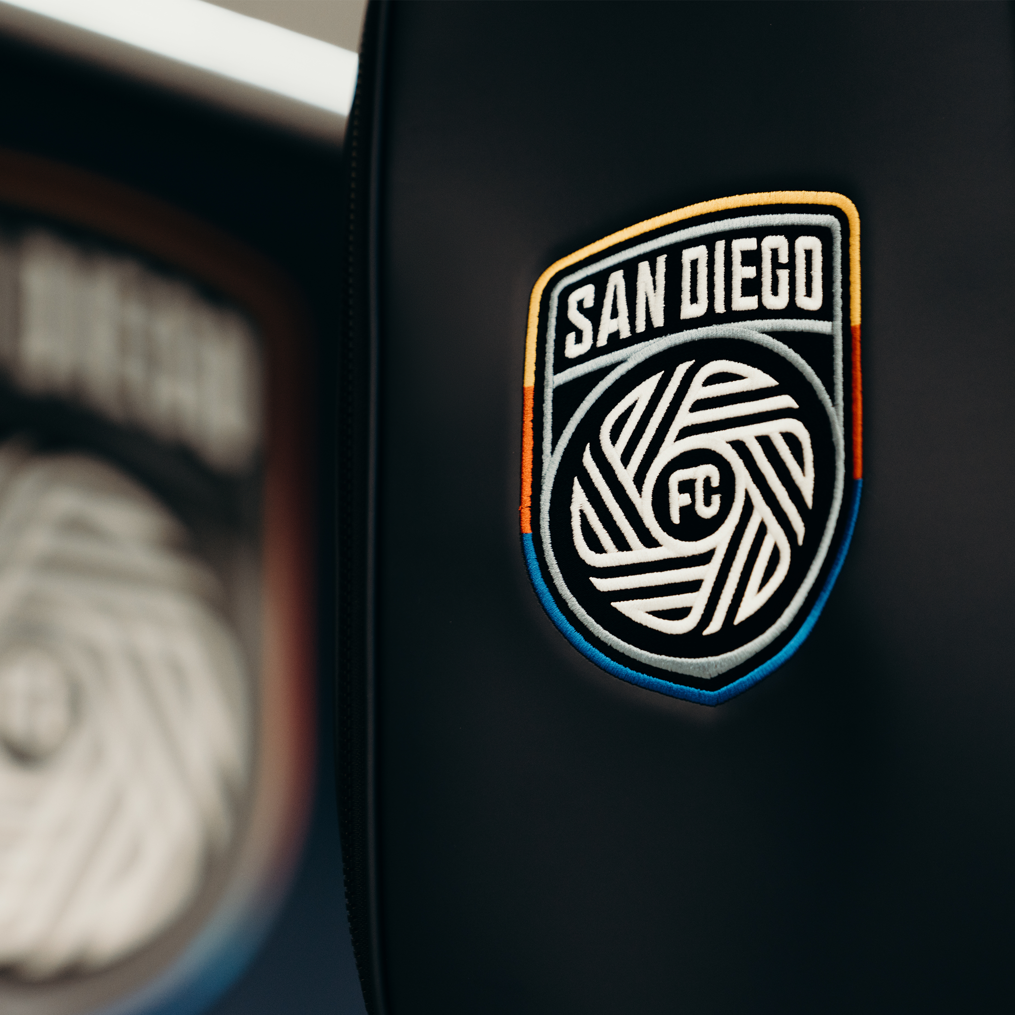 Close up image of a navy prime 2.0 staff bag with the San Diego FC Logo embroidered on the front.