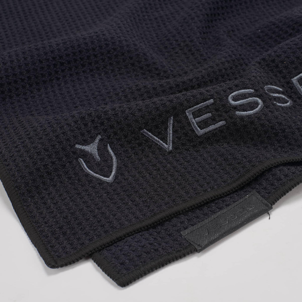 Close up of embroidered logo on black  Microfiber Club Towel #color_black